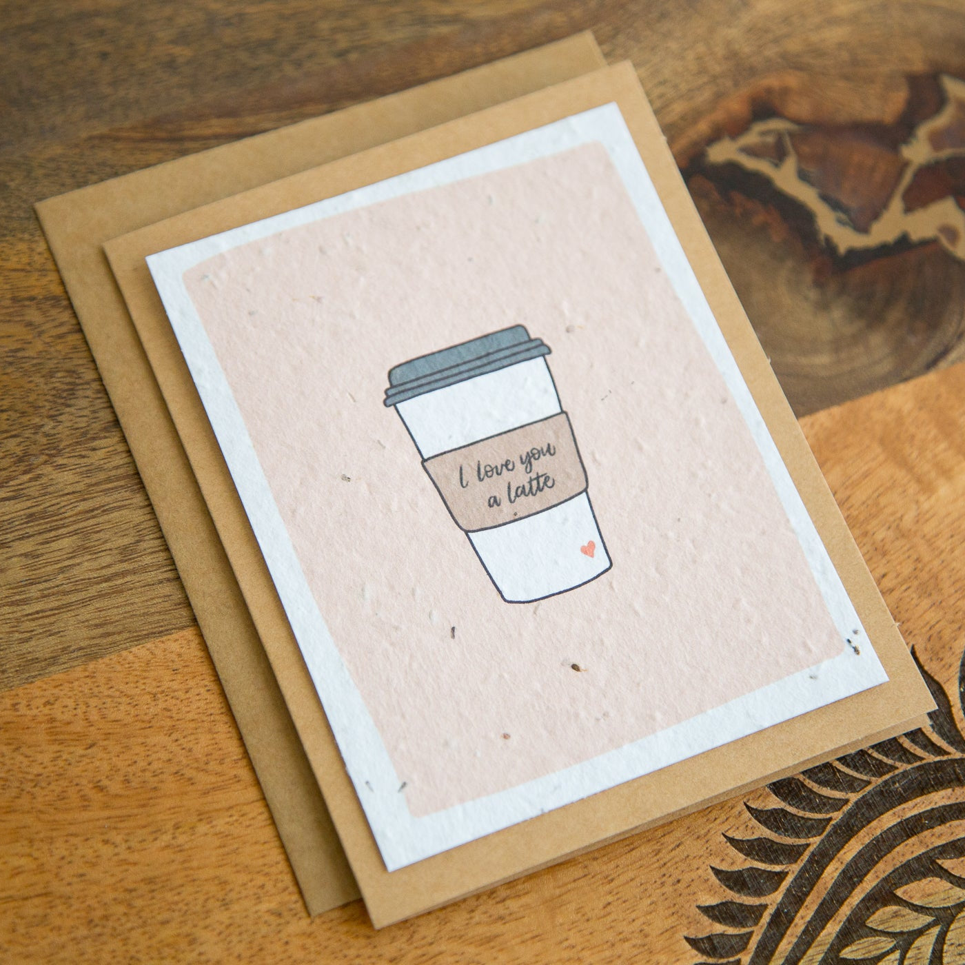 Greeting card with a coffee cup illustration and the words "I love you a latte" hand written