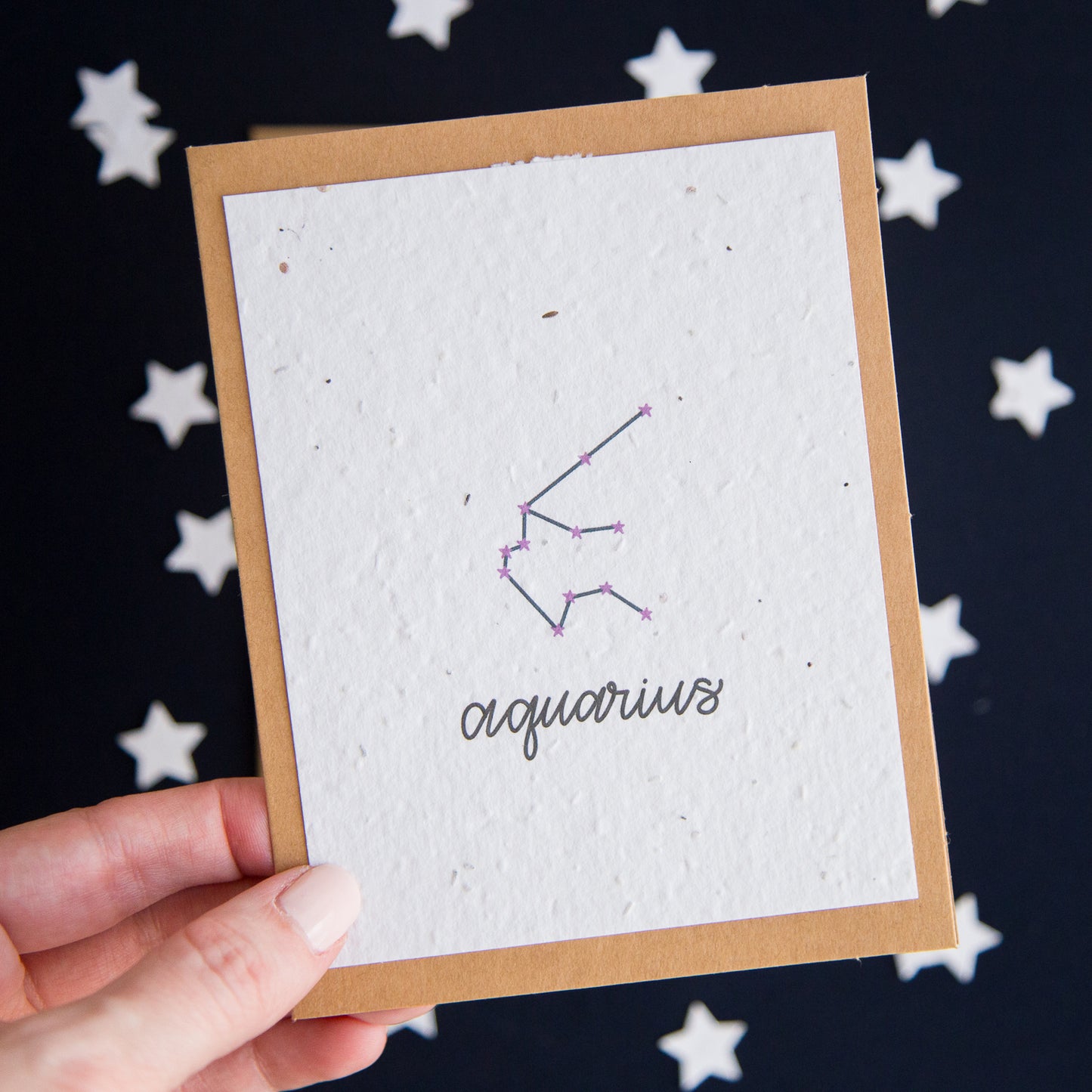 A greeting card with the Aquarius constellation and word “Aquarius” printed on plantable seed paper