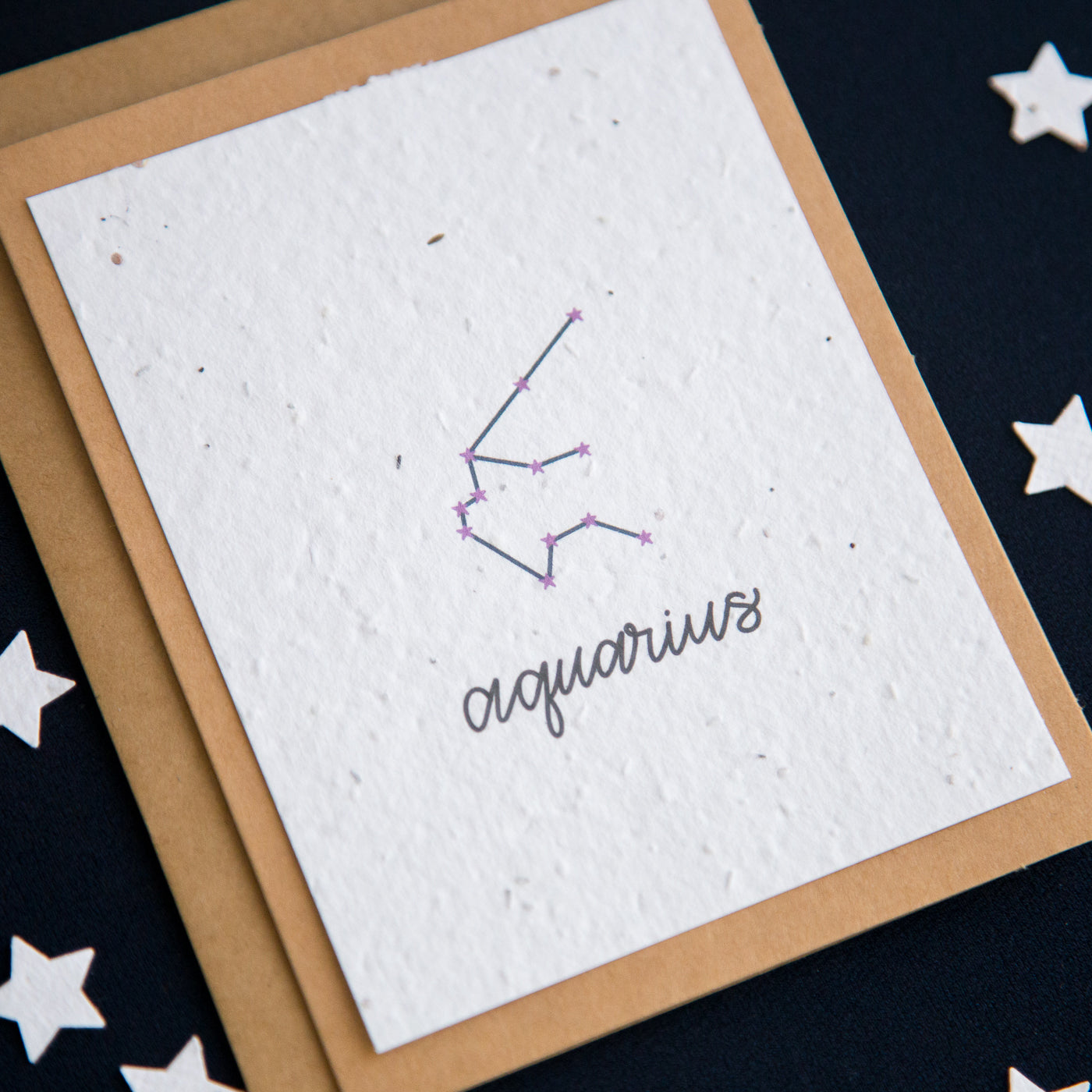 A greeting card with the Aquarius constellation and word “Aquarius” printed on plantable seed paper