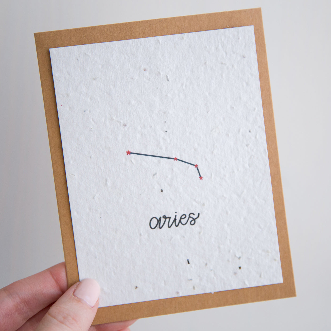 A greeting card with the Aries constellation and word “Aries” printed on plantable seed paper