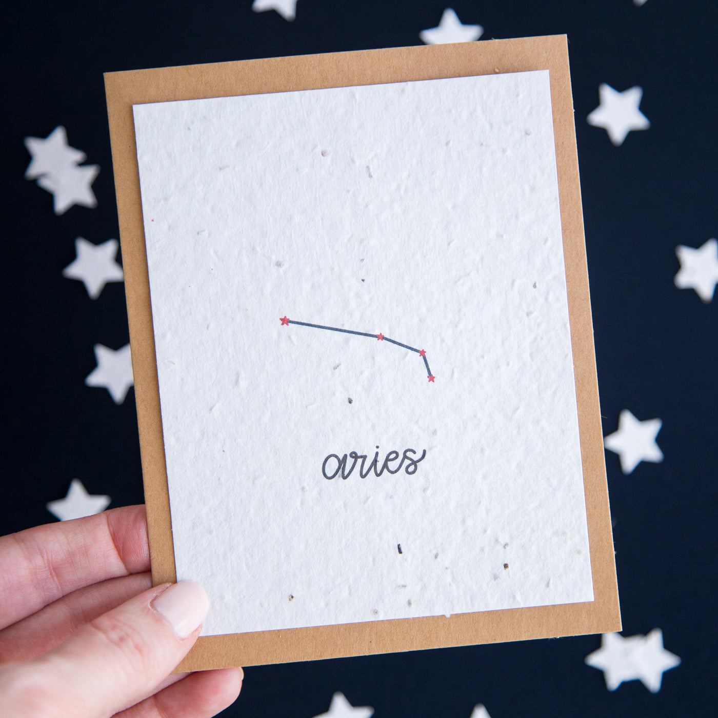 A greeting card with the Aries constellation and word “Aries” printed on plantable seed paper