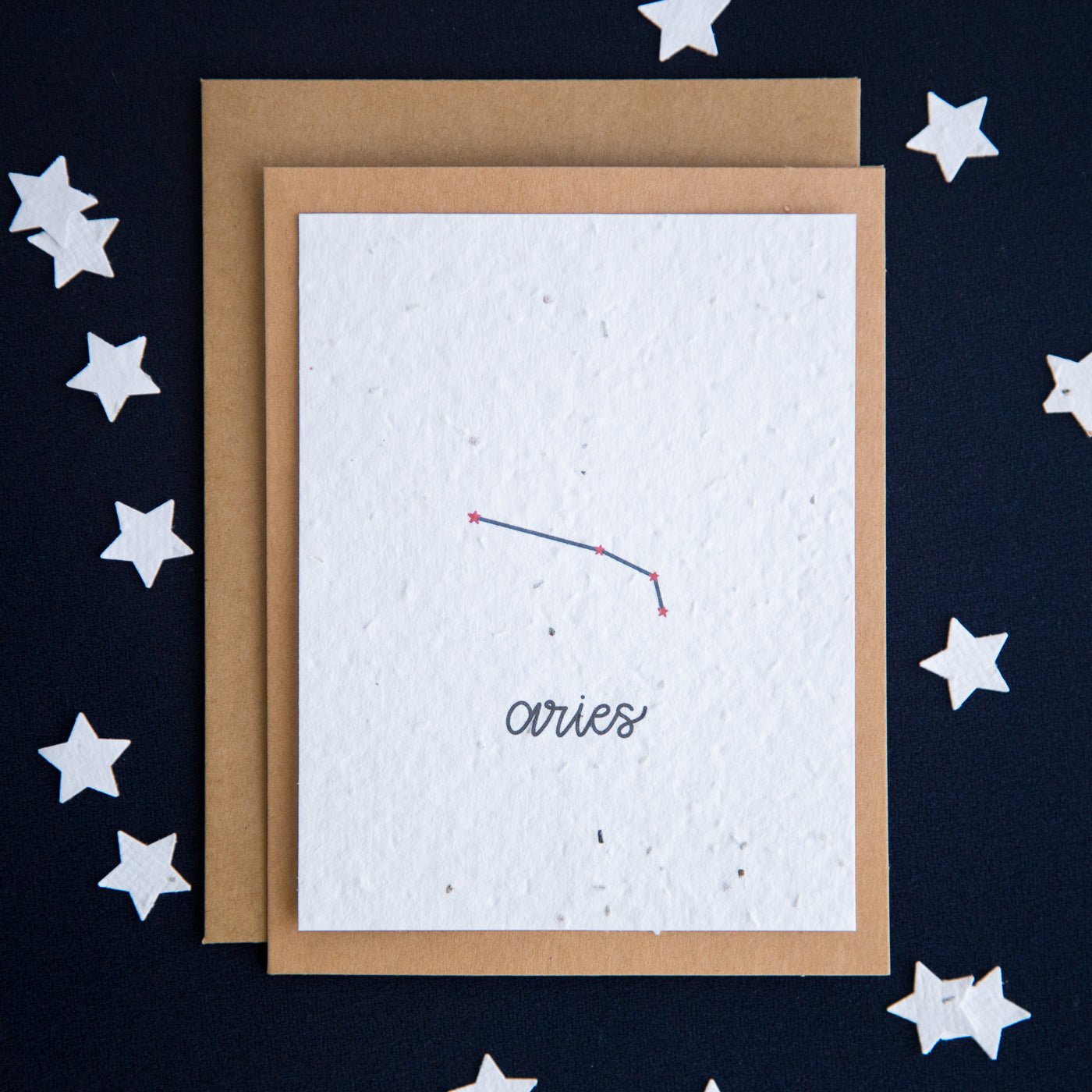 A greeting card with the Aries constellation and word “Aries” printed on plantable seed paper