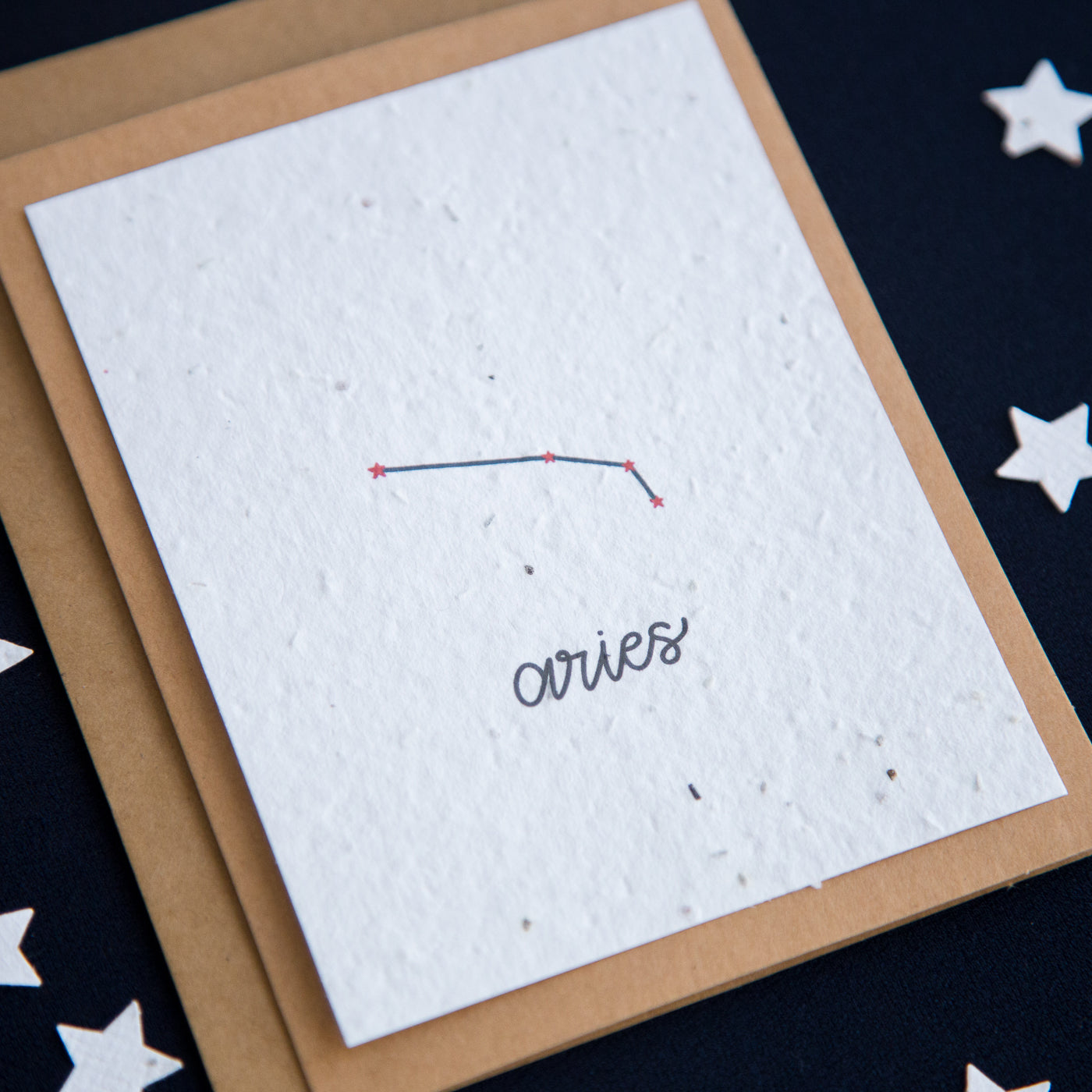 A greeting card with the Aries constellation and word “Aries” printed on plantable seed paper