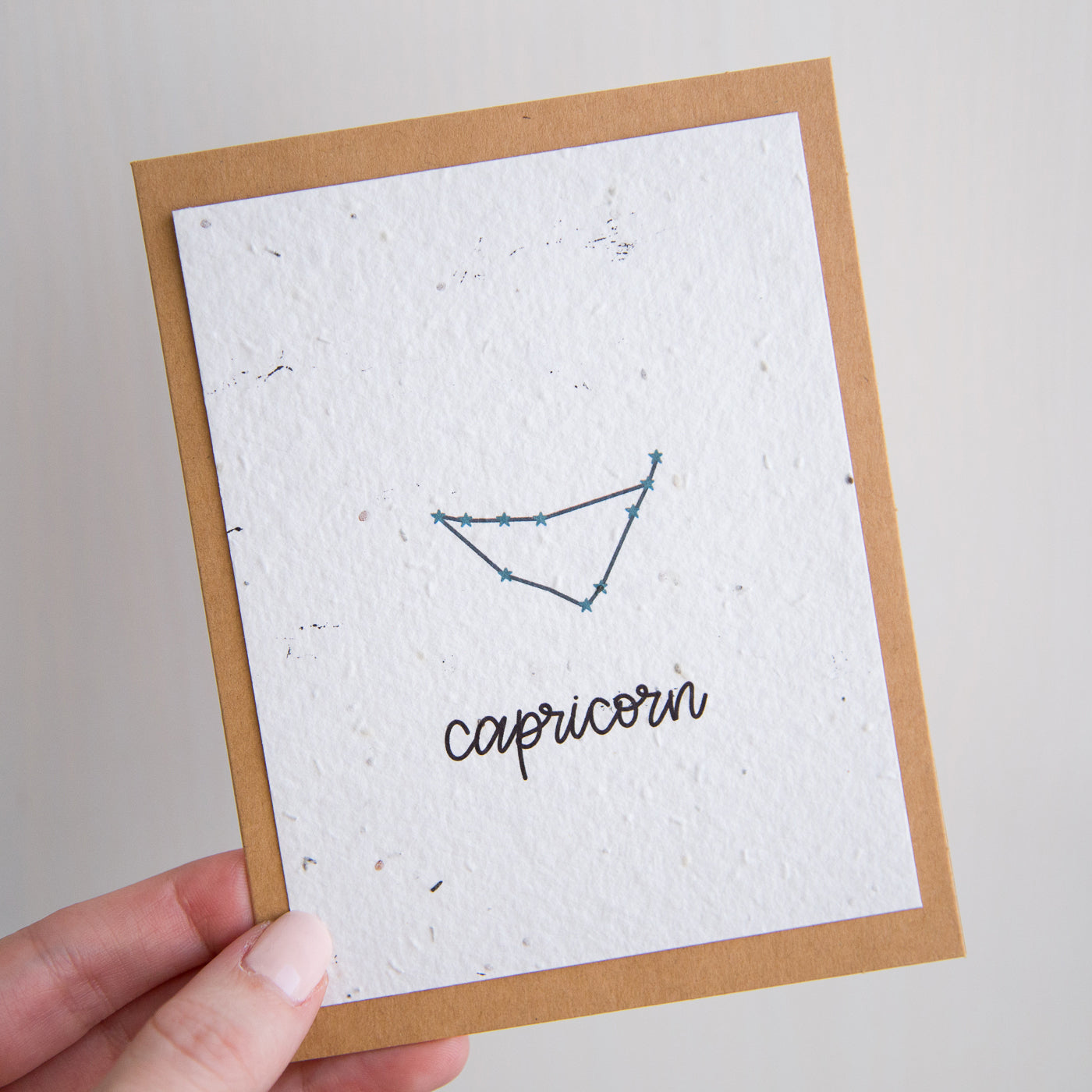 A greeting card with the Capricorn constellation and word “Capricorn” printed on plantable seed paper