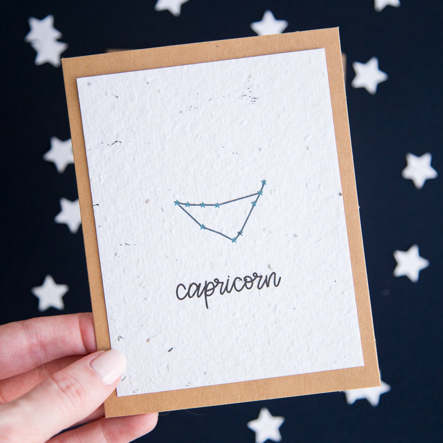 A greeting card with the Capricorn constellation and word “Capricorn” printed on plantable seed paper