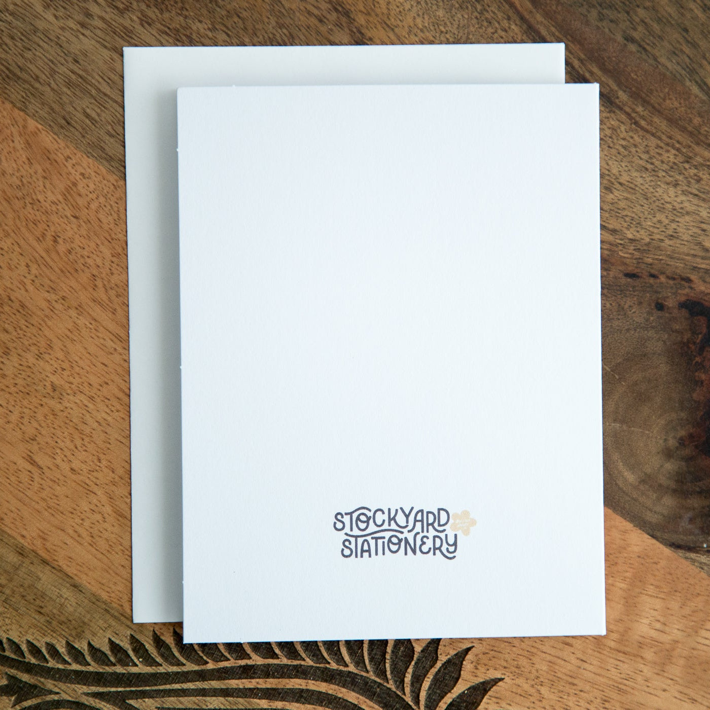 White card with 'Stockyard Stationery' logo on a wooden surface