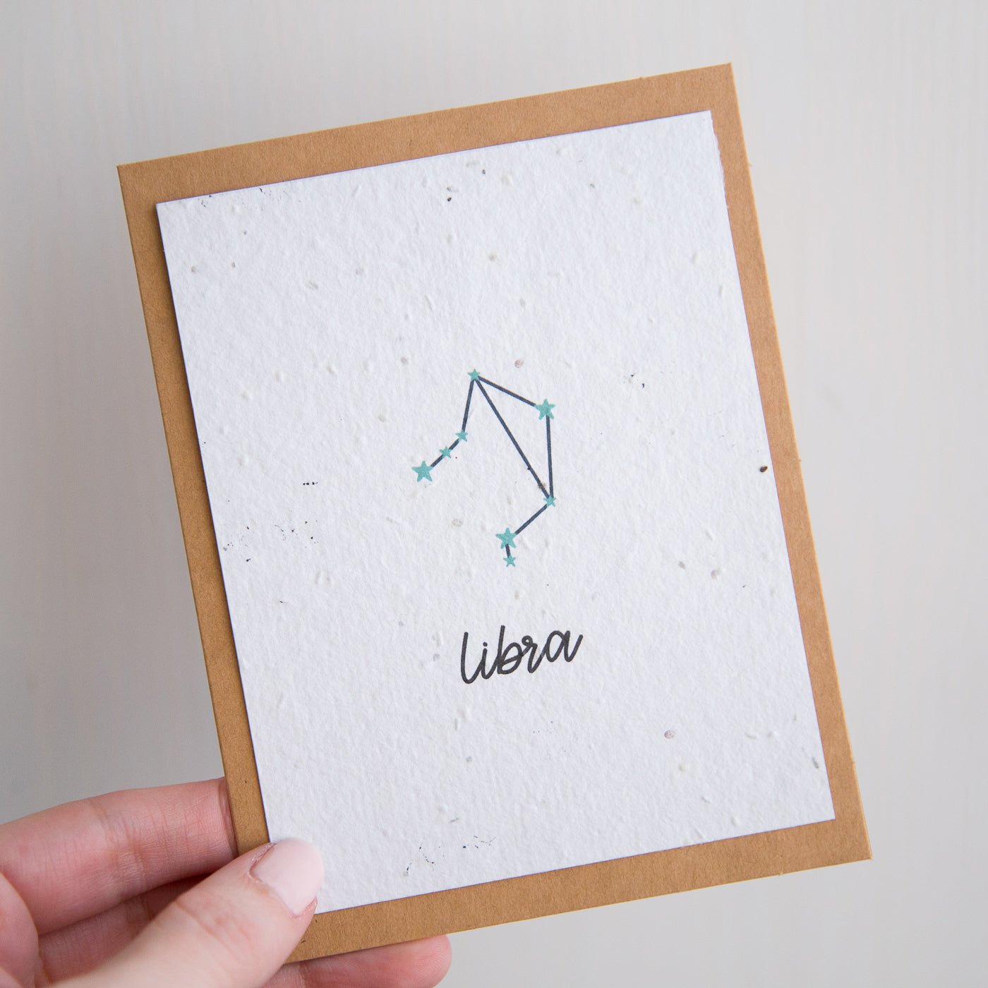 A greeting card with the Libra constellation and word “Libra” printed on plantable seed paper