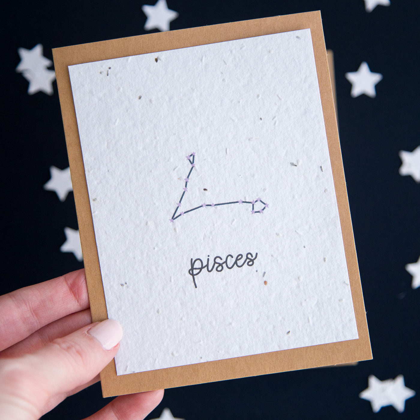 A greeting card with the Pisces constellation and word “Pisces” printed on plantable seed paper