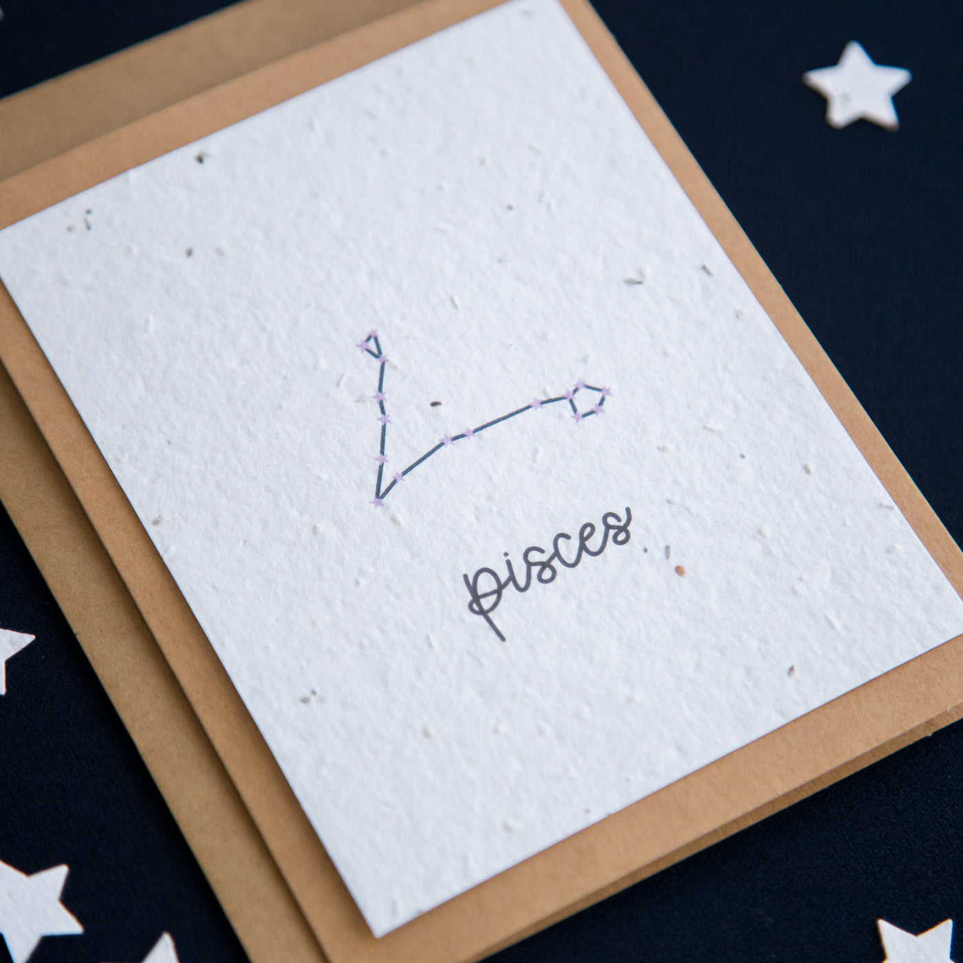 A greeting card with the Pisces constellation and word “Pisces” printed on plantable seed paper