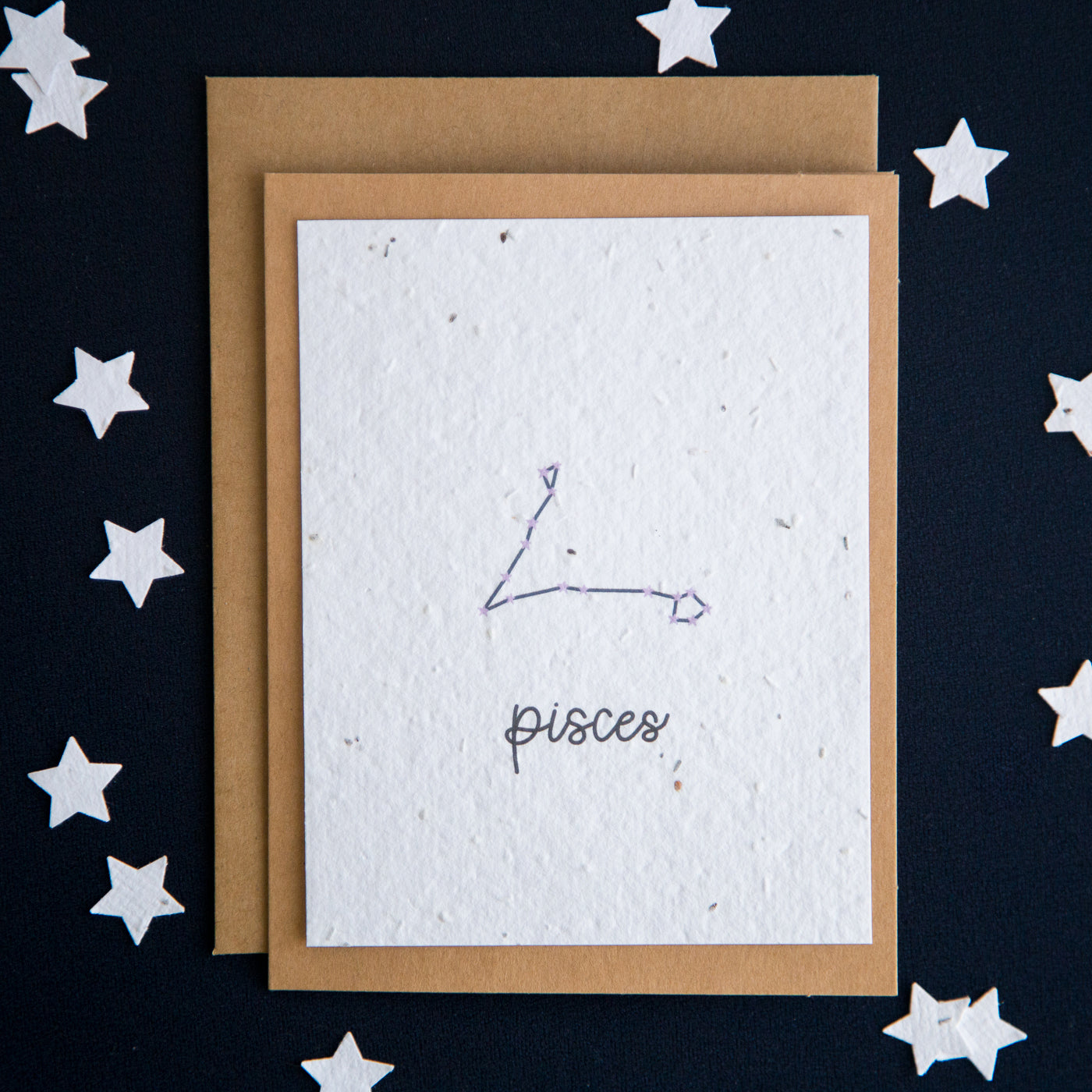 A greeting card with the Pisces constellation and word “Pisces” printed on plantable seed paper