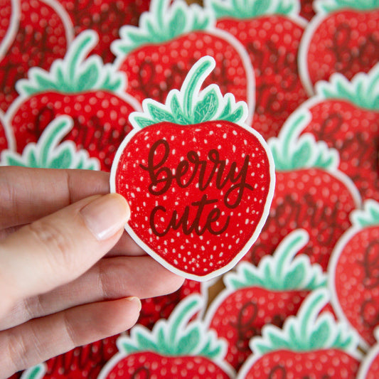 Sticker with 'Berry Cute' text written on a strawberry sticker