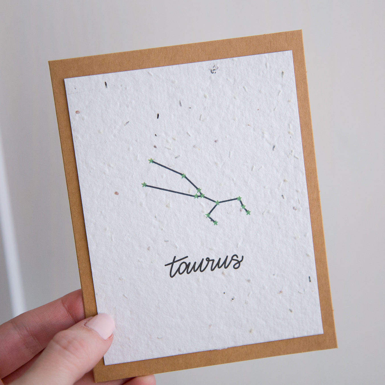 A greeting card with the Taurus constellation and word “Taurus” printed on plantable seed paper