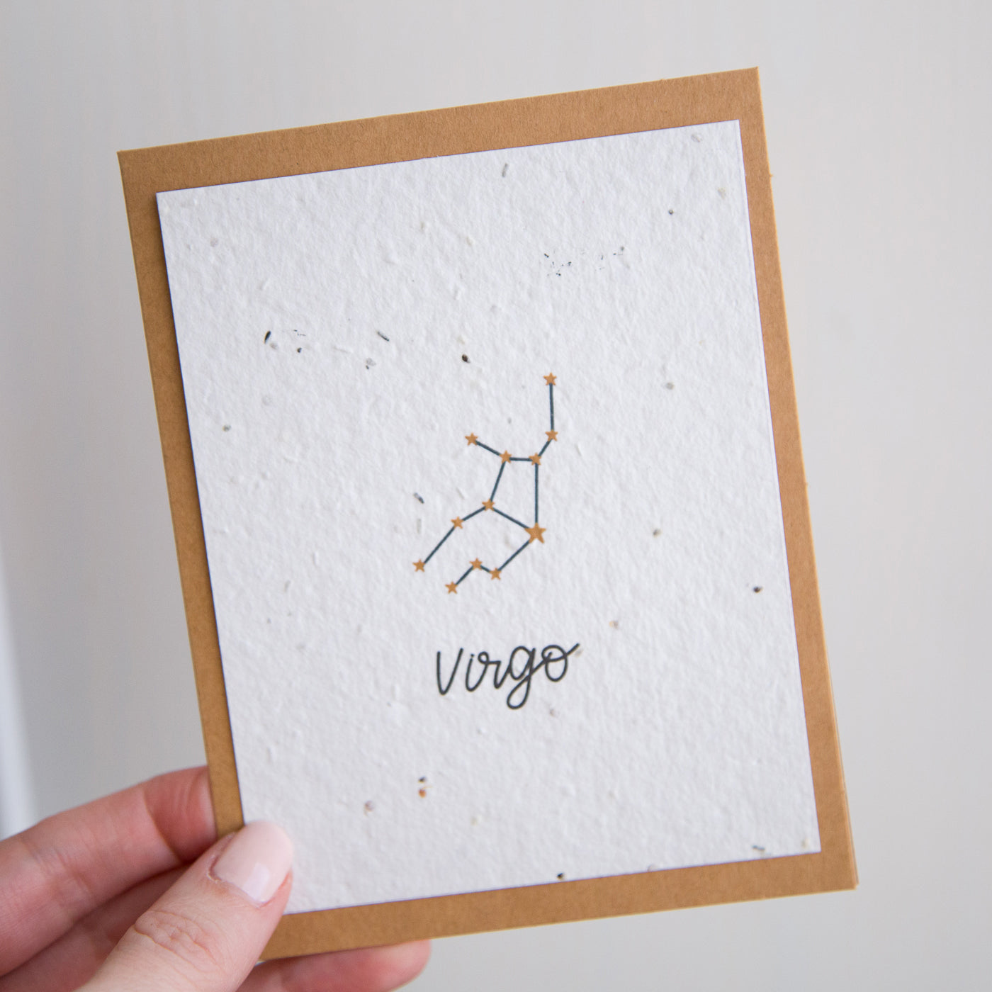 A greeting card with the Virgo constellation and word “Virgo” printed on plantable seed paper