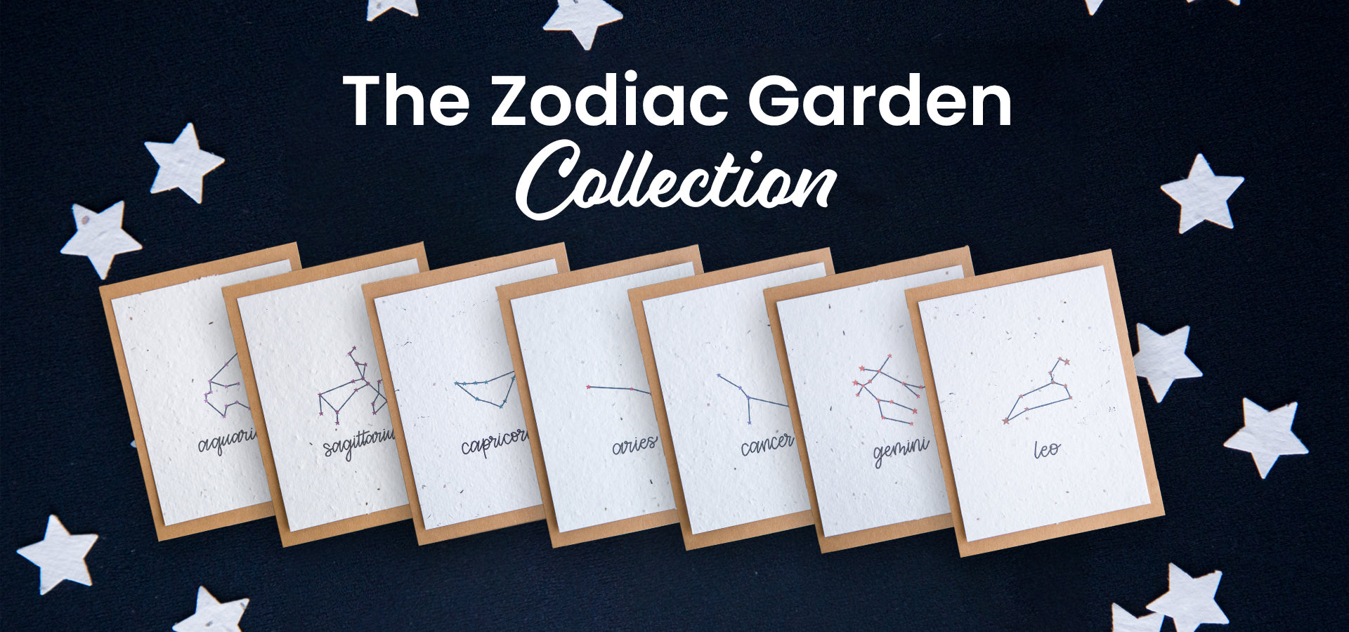 A dark background with 7 zodiac greeting cards displayed in a line with the words “The Zodiac Garden Collection” above