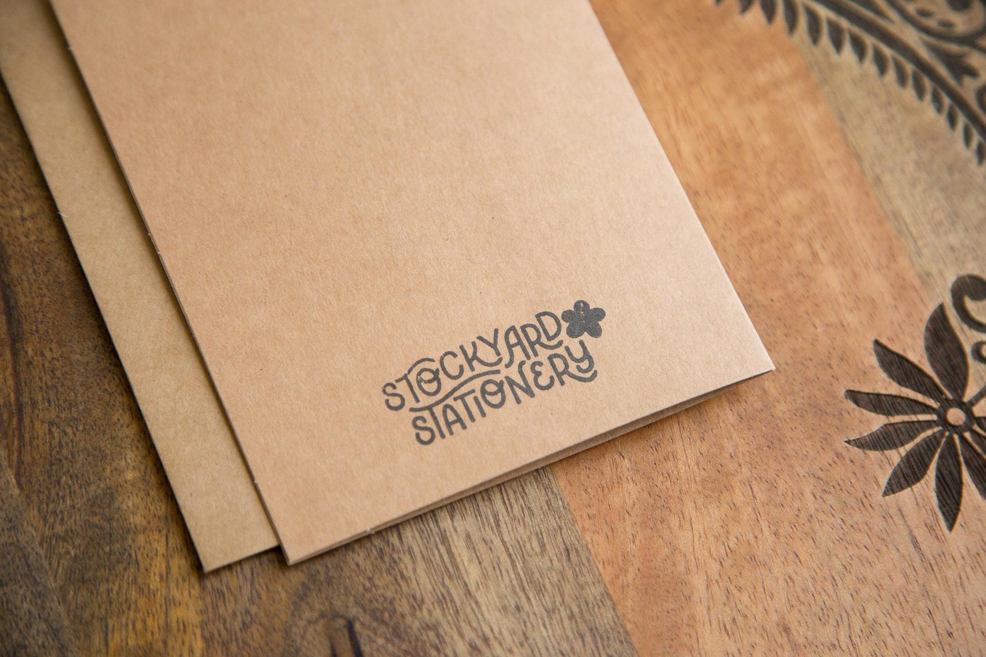 A kraft paper greeting card with a black stamped logo saying "Stockyard Stationery"