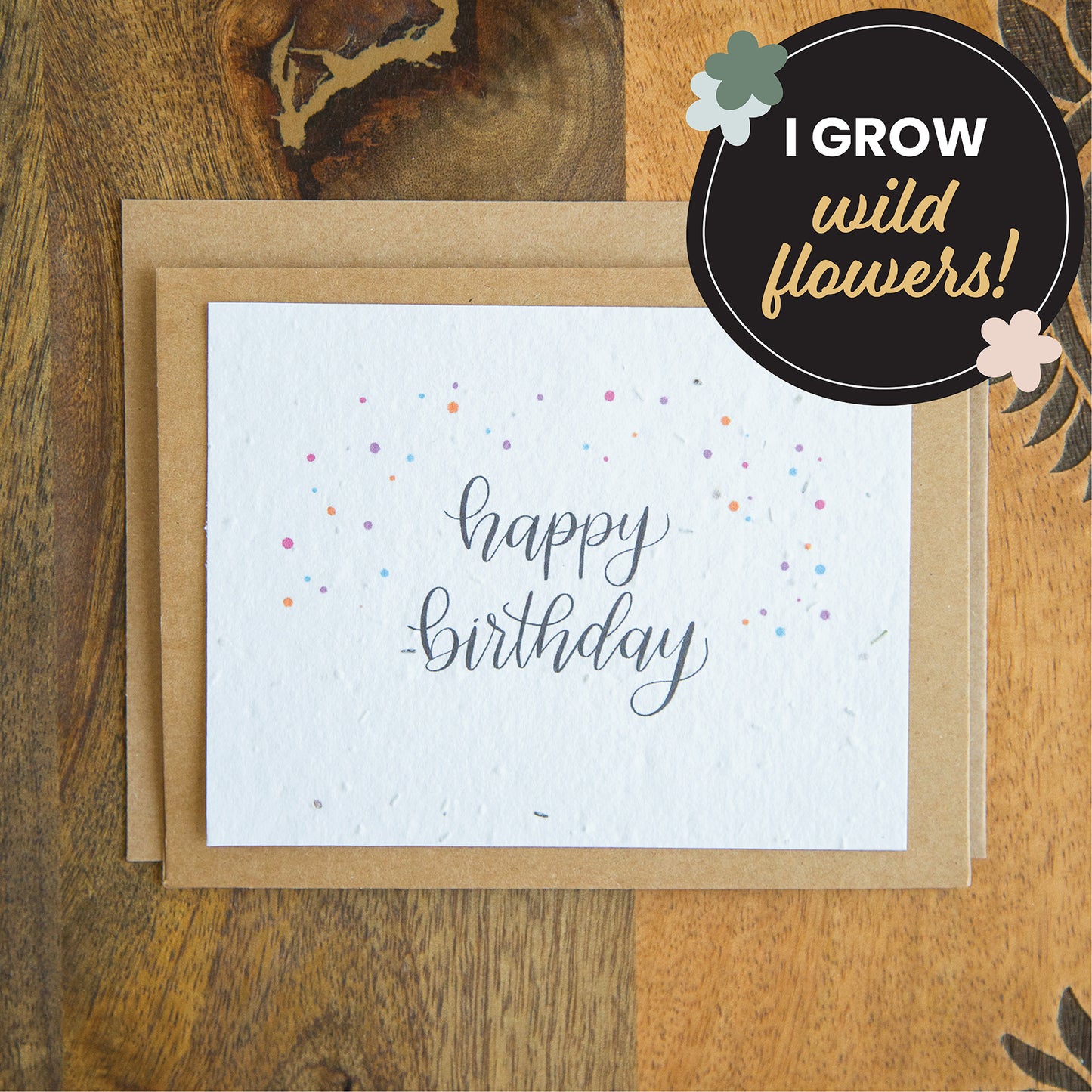 a kraft paper greeting card with plantable seed paper and the words "happy birthday" written in calligraphy