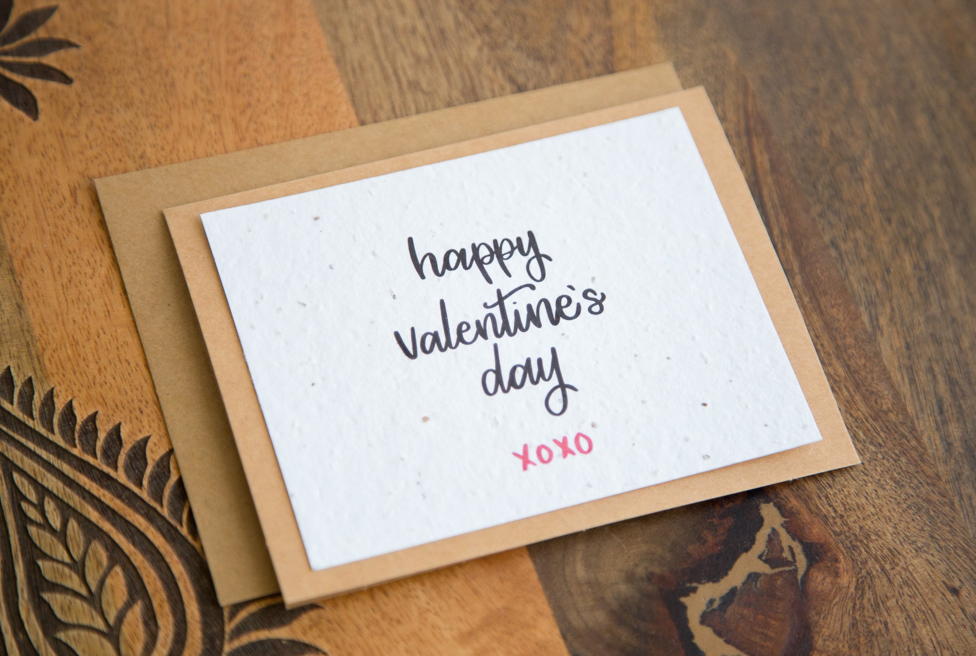 Plantable greeting card with the words "happy Valentine's Day xoxo" printed in calligraphy in black on white paper